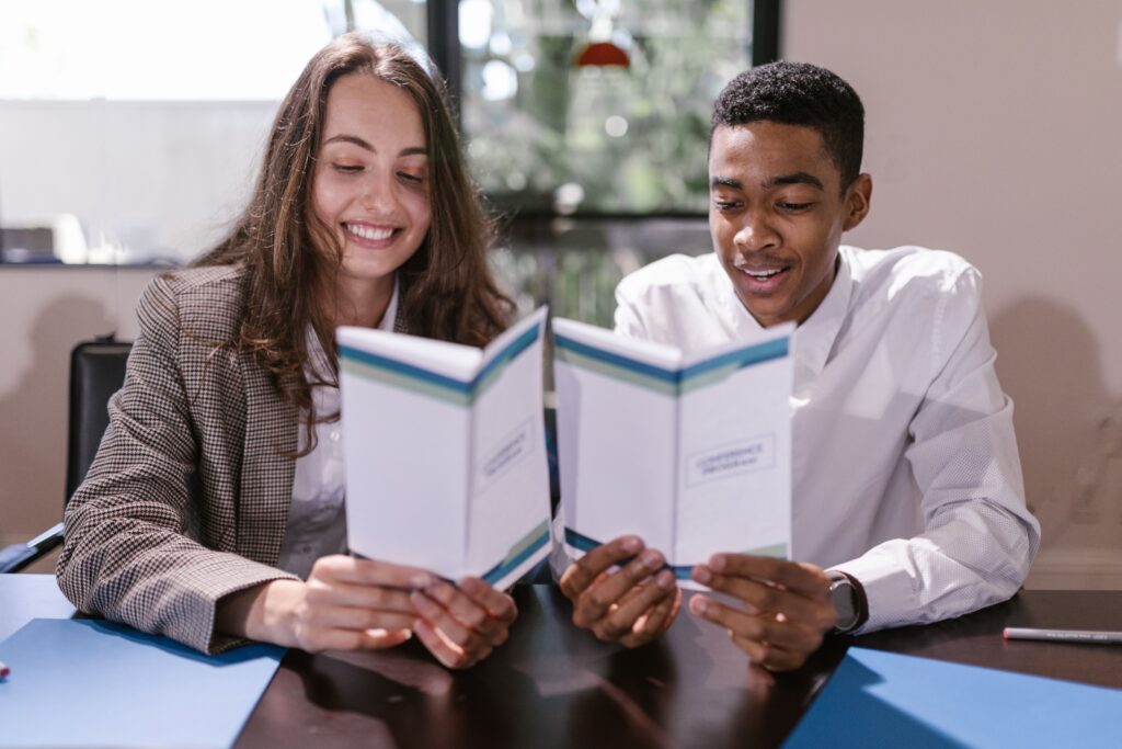 Two professionals reviewing financial documents together in office
